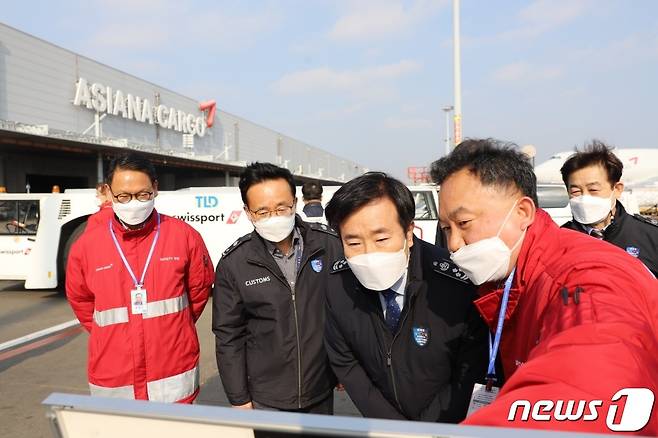 19일 인천공항 아시아나 화물터미널에서 김윤식 인천본부세관장(왼쪽 세번째)이 문정석 지점장으로부터 계류장 직반출을 통한 백신반출 절차에 대해 설명을 듣고 있다.(인천본부세관 제공)2021.2.19/뉴스1 © News1 박아론 기자