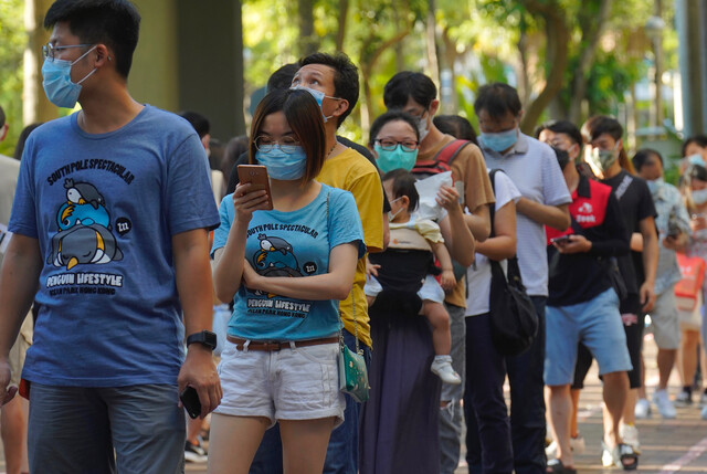 지난해 7월12일 홍콩 범민주진영 입법의원 선거 후보 선출을 위해 민주동력 주도로 열린 자체 경선에 참여하기 위해 마스크를 쓴 홍콩 시민들이 길게 줄을 서 있다. 홍콩/AP 연합뉴스