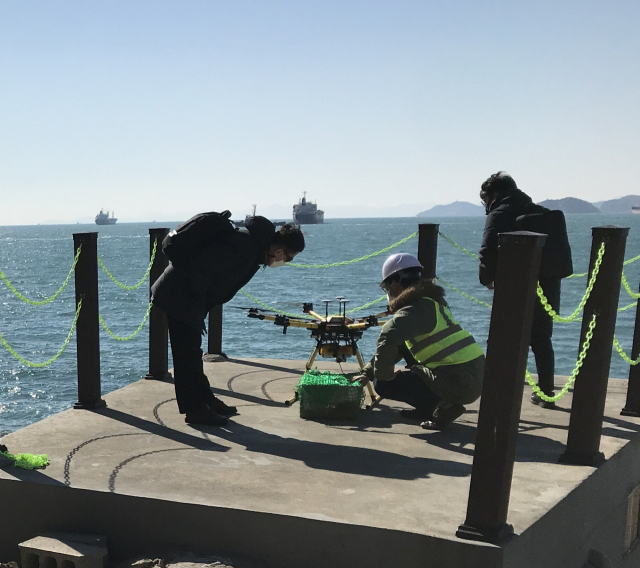Employees launch a drone to deliver items to ships near Busan Port. (Marine Drone Tech)