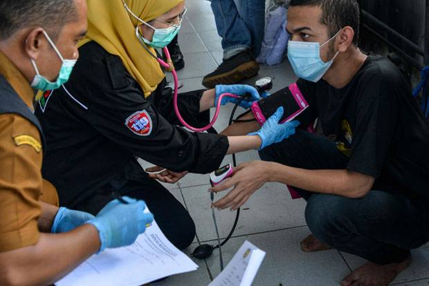 마스크를 쓰고 태형 장소에 집결한 이들은 태형대로 향하기 전 의료진의 진찰을 받았다. 건강에 이상이 없음을 확인한 후 수갑을 찬 채 태형대에 무릎을 꿇었으며, 죄질에 따라 10~20대의 매질을 당했다./사진=AFP 연합뉴스