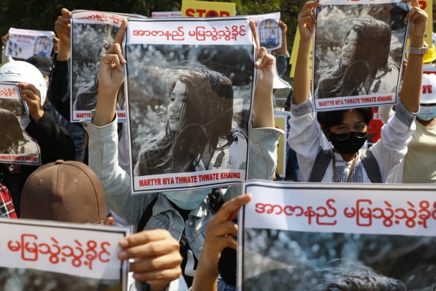지난 14일 미얀마 시민들이 시위 도중 군경 실탄에 맞아 당시 뇌사상태였던 한 시민의 사진을 들어보이고 있다. 이 시민은 지난 19일 사망했다.  /사진=AP연합뉴스