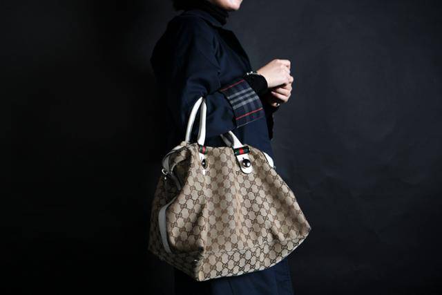 대학생 신현주씨가 입학선물로 어머니로부터 받은 25년 전 명품 코트를 입고, 가방을 들고 있다. 이한호 기자 han@hankookilbo.com