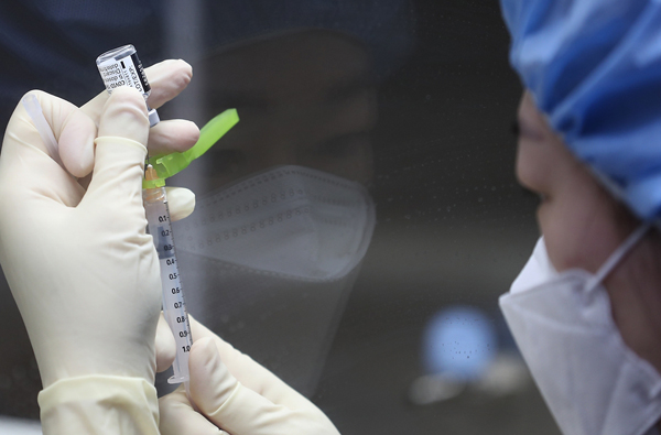 지난 2월 서울 국립중앙의료원 중앙접종센터에서 의료진이 화이자 백신을 주사기에 옮겨 담고 있다.