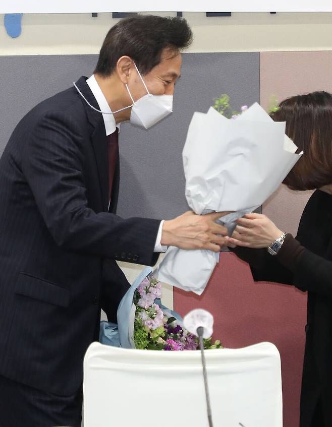 오세훈 서울시장이 16일 시청에서 사회복지 직능단체장들과의 간담회에서 축하 꽃다발을 받고 있다. 연합뉴스