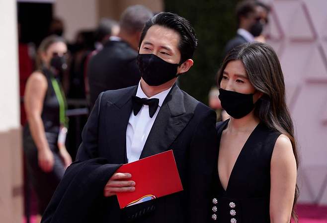 Steven Yeun, nominated for an Academy Award for Actor in a Leading Role for his performance in "Minari" and his wife Joana Pak, arrive at the Oscars on April 25, 2021, at Union Station in Los Angeles. (AFP-Yonhap)
