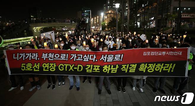 인천 검단·경기 김포 시민들로 구성된 김포검단교통시민연대가 8일 김포시 장기동 라베니체에서 'GTX-D서울직결·5호선 김포연장 촛불집회'를 하고 있다. 2021.5.8/뉴스1 © News1 정진욱 기자