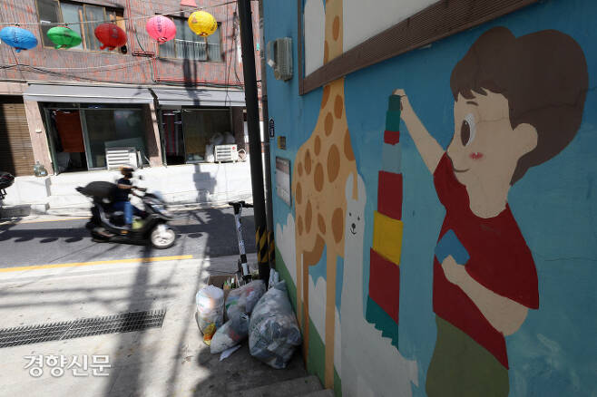 서울 종로구 창신동 봉제거리의 한 건물에 그려진 벽화 앞에 쓰레기가 놓여져 있다. 권도현 기자