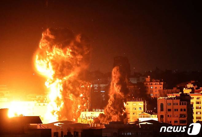 17일(현지시간) 팔레스타인 가자시티 건물에서 이스라엘 군의 폭격으로 화염과 연기가 치솟고 있다. © AFP=뉴스1 © News1 우동명 기자