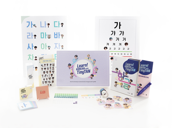 The "Learn! Korean with TinyTAN" Korean language learning package developed by HYBE Edu consists of a “Student Book,” “Workbook,” the MotiPen, a set of vocabulary cards, a set of alphabet cards, two rolls of patterned tape and a pack of stickers including the Korean alphabet and the TinyTAN characters. [HYBE EDU]