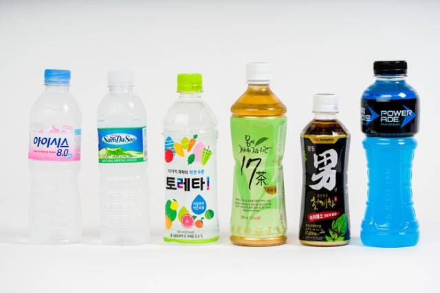 투명 PET병을 사용한 제품들이 나열돼 있다. 왼쪽 두 제품은 접착제가 발린 '접착식 라벨'을 사용하고, 오른쪽 4개 제품은 접착제가 없고 소비자가 뜯기 편하게 절취선을 새긴 '비접착식 절취선 라벨'을 사용한다. 한진탁 인턴기자