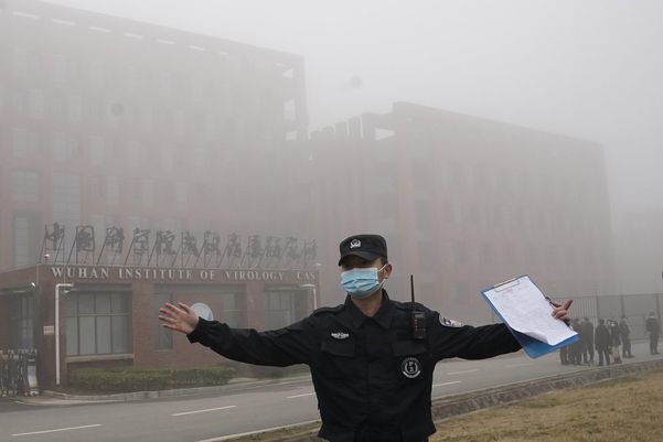 지난 4월 중국 우한 바이러스연구소 주변에서 한 보안요원이 취재진을 제지하고 있다. /연합뉴스