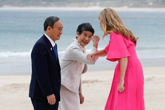 스가 총리(왼쪽)의 부인 마리코(가운데) 여사가 영국 총리 부인 캐리 시먼즈(오른쪽)와 인사를 나누고 있다. 로이터=연합뉴스