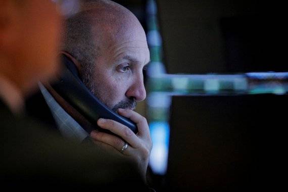 미국 뉴욕 맨해튼의 뉴욕증권거래소(NYSE)에서 13일(현지시간) 한 트레이더가 심각한 표정으로 모니터를 들여다보며 전화 통화를 하고 있다. 로이터뉴스1