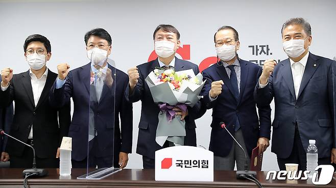야권 대선주자인 윤석열 전 검찰총장이 30일 오후 서울 여의도 국민의힘 중앙당사에서 대외협력위원장인 권영세 의원에게 입당원서를 제출한 뒤 꽃다발을 들고 기념촬영을 하고 있다2021.7.30/뉴스1 © News1 구윤성 기자