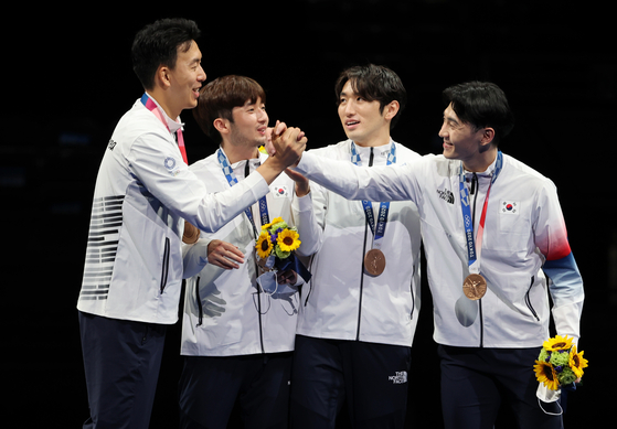From left, Kweon Young-jun, Ma Se-geon, Park Sang-young and Song Jae-ho celebrate winning the men's team epee bronze medal at the 2020 Tokyo Games podium on July 30 in Chiba, Japan. [NEWS1]