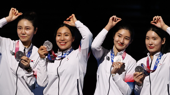 The Korean national women’s epee team, from left, Choi In-jeong, Kang Young-mi, Lee Hye-in and Song Se-ra, celebrate their silver medal on July 27 at the Makuhari Messe Hall in Tokyo. [YONHAP]