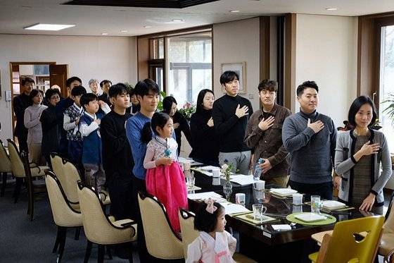 2019년 최재형 전 감사원장 가족이 명절 모임에서 국민의례를 하는 모습. 맨 뒷줄에 서 있는 사람이 최 전 원장. 가족 모임때는 국민의례를 하고, 애국가를 4절까지 완창하는 게 최 전 원장 가족의 전통이다. [최재형 캠프 제공]