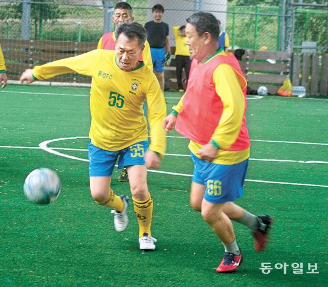 황덕진 씨(왼쪽)가 경남 통영시 청구풋살구장에서 열린 통영 FC 자체 친선게임에서 볼을 다투고 있다. 올해로 70세인 그는 무릎 및 허리 수술을 했지만 체계적인 재활로 몸을 만들어 주 1회 축구를 하고 있다. 통영=양종구 논설위원 yjongk@donga.com