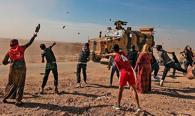 2019년 시리아인 여성과 아이들이 자국 북동부 하사케 지역에서 순찰 중인 터키 군용 차량을 향해 돌을 던지는 모습이다. 1988년부터 2012년까지 중동 지역을 덮친 가뭄은 2011년 발발해 10년째 이어지는 시리아 내전의 원인 중 하나로 꼽힌다. 세계일보 자료사진