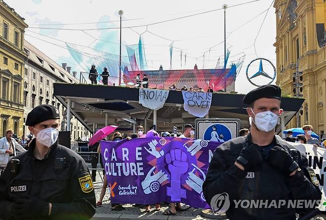 독일 뮌헨 오데온 광장의 메르세데스-벤츠 전시장 점거한 IAA 모빌리티 반대 시위대와 진압하는 경찰[AFP=연합뉴스]