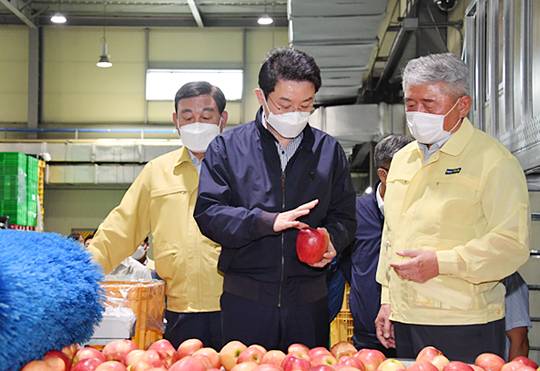 현장으로… : 이억원(가운데) 기획재정부 1차관이 15일 충남 예산능금농협 유통센터를 방문해 선별장을 둘러보며 관계자의 설명을 듣고 있다.  기재부 제공