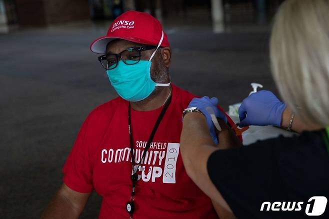 (사우스필드 AFP=뉴스1) 우동명 기자 = 24일 (현지시간) 미시간주 사우스필드에 있는 코로나19 백신 접종소에서 주민이 모더나 백신 부스터샷을 맞고 있다.  (C) AFP=뉴스1