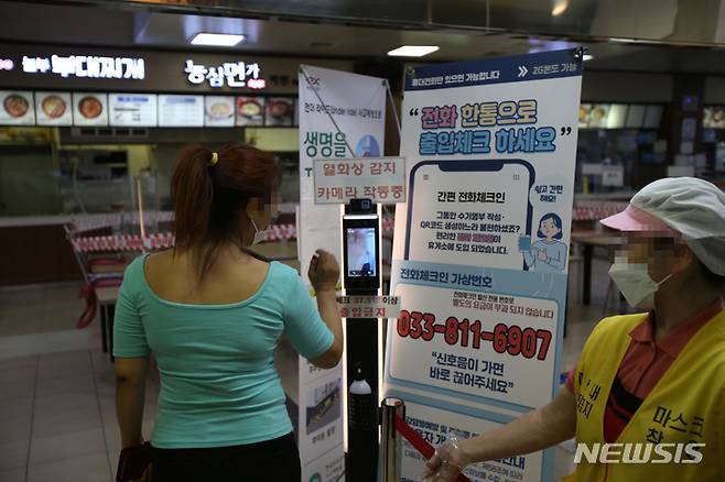 [춘천=뉴시스] 김경목 기자 = 추석연휴를 하루 앞둔 17일 오후 한 여성이 강원 춘천시 중앙고속도로 부산 방향 춘천휴게소 입장 전 발열 체크를 하고 있다. 2021.09.17. photo31@newsis.com