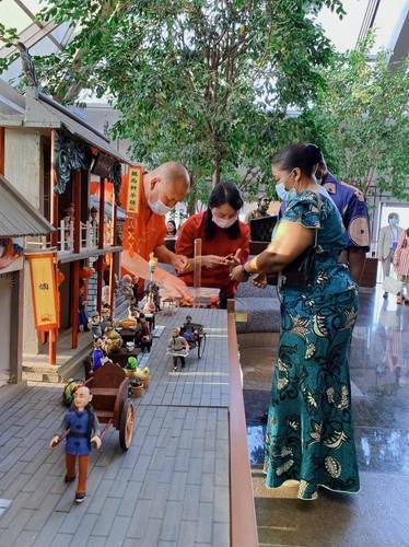 Third Secretary of Zimbabwe and his family making dough figures, a traditional Chinese art form.