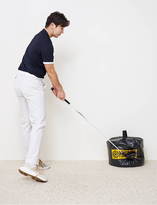 훈련 방법
➊ 선택한 클럽의 공 위치에 파워백을 둔다.
➋ 클럽을 지면에서 5cm 정도 들고 셋업한다. ➌ 손목 부상에 유의하며 파워백 옆면 중앙의 이미지를 강타한다.