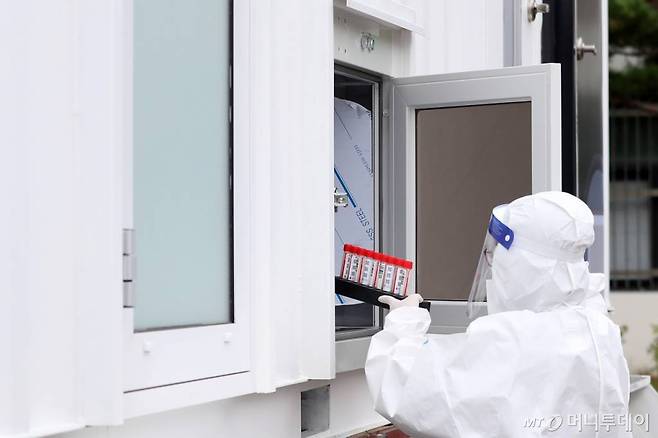 28일 오전 '신속 자가분자진단 유전자증폭(신속 PCR)' 검사소가 마련된 서울 종로구 동성고등학교에서 의료진이 학생들에게 채취한 검체를 검사소 바로 옆에 위치한 이동형 검사실로 옮기고 있다.   서울시교육청은 '교육시설 이동검체팀'을 1개팀에서 4개 팀 이상으로 확대하고, 기숙사 운영 학교 5개교를 대상으로 신속 PCR 검사를 시범 운영하는 등 다음 달 6일까지 '다중적 방역 집중 기간'으로 지정했다. /사진=김휘선 기자 hwijpg@