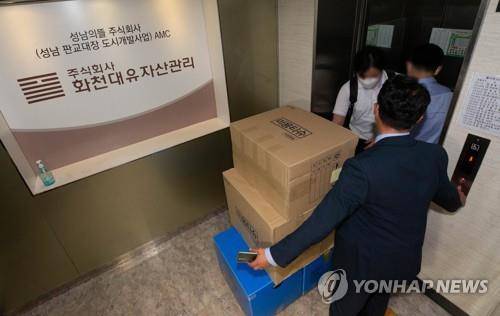 화천대유 압수수색 마친 검찰     (성남=연합뉴스) 홍기원 기자 = 29일 오후 경기도 성남시 화천대유자산관리 사무실에서 압수수색을 마친 검찰 관계자들이 압수품을 옮기고 있다. 
    검찰은 경기 성남시 대장동 개발사업의 특혜 의혹을 받는 자산관리회사 화천대유와 관련자들의 사무실·주거지 등을 압수수색하며 본격 수사에 착수했다. 2021.9.29 [공동취재]
    xanadu@yna.co.kr