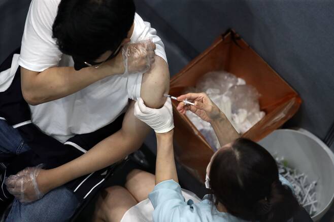 정부가 10월 1일 사회적 거리두기 발표 내용에 '백신패스'는 포함되지 않는다고 밝힌 30일 오후 서울 송파구 체육문화센터에 마련된 예방접종센터에서 한 시민이 백신 접종을 받고 있다. 2021.09.30/뉴시스