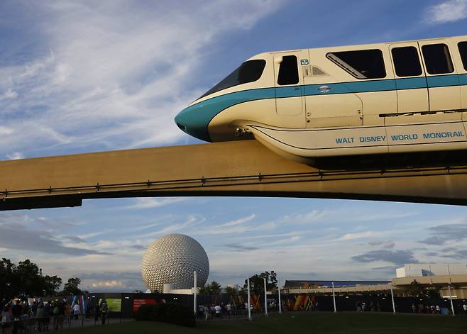 The Walt Disney World Monorail System passes by Spaceship Earth.