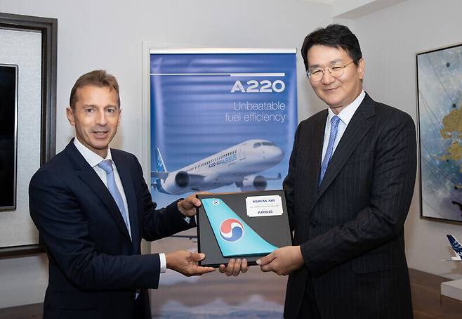 Cho Won-tae, chairman of Korean Air, receives the Airbus A220 Best Operational Excellence 2021 award from Airbus CEO Guillaume Faury. (provided by Korean Air)