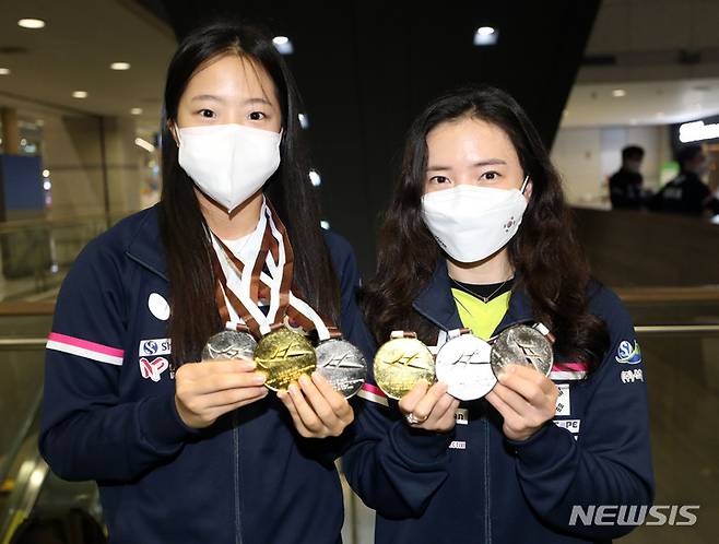 [인천공항=뉴시스] 고범준 기자 = 한국 여자탁구대표팀 전지희와 신유빈이 카타르 도하에서 열린 2021 ITTF-ATTU 아시아탁구선수권대회 여자 복식 결승전에서 우승을 차지하고 6일 오후 인천국제공항 제1터미널을 통해 귀국해 메달을 들고 포즈를 취하고 있다. 2021.10.06. bjko@newsis.com