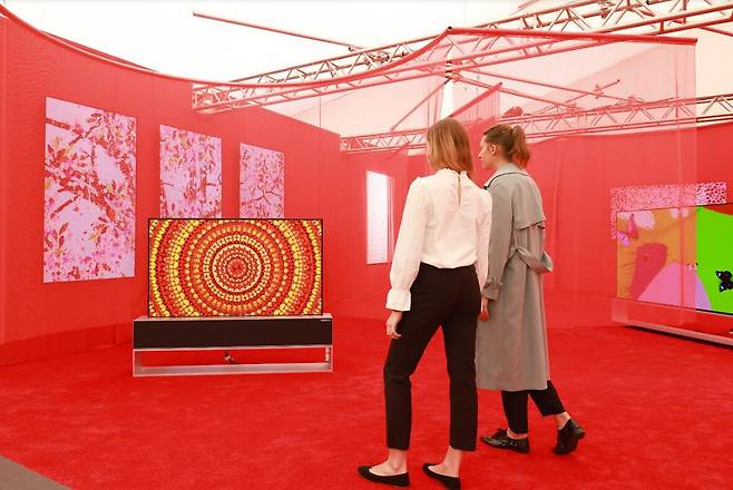LG 갤러리를 찾은 관람객들이 롤러블 올레드 TV LG 시그니처 올레드 R로 데미안 허스트의 예술 작품을 감상하고 있다./LG전자 제공