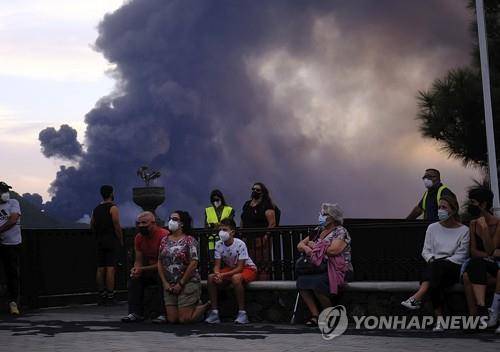 기도 행렬을 바라보는 라팔마섬 주민들 (라팔마<스페인> AP=연합뉴스) 19일(현지시간) 스페인령 카나리아제도 라팔마섬에서 화산 분출이 멈추기를 기도하는 행렬을 마을 주민들이 바라보고 있다. 2021.10.20 photo@yna.co.kr