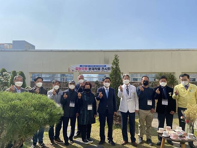 [창원=뉴시스] 강경국 기자 = 허성무 경남 창원시장이 22일 당당한방병원 창원점 건물 옥상에서 열린 창원국화 분재작품 전시회에 참석해 기념촬영을 하고 있다. (사진=창원시청 제공). 2021.10.22. photo@newsis.com *재판매 및 DB 금지