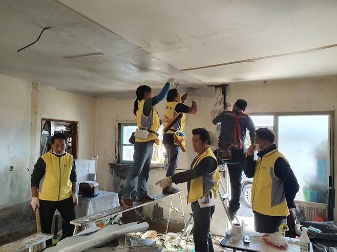 [뉴시스=공주]독거노인 가정을 방문, 방 도배 봉사를 하고 있는 공주시 특수임무 고마봉사단.2021.10.25.(사진=공주시 제공) *재판매 및 DB 금지