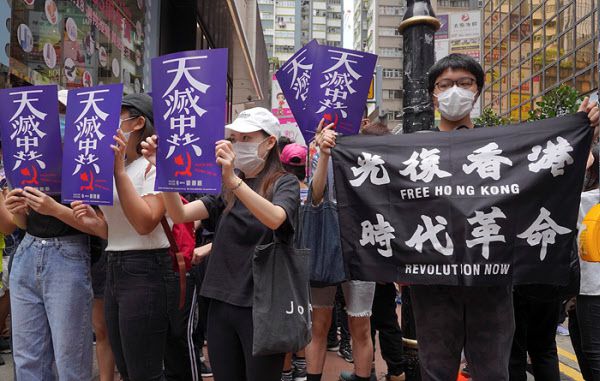 2020년 7월 24일 홍콩 시내 홍콩섬 도심에서 열린 시위에서 시위대 참가자들이 "하늘이 중국공산당을 멸망시킬 것"이라는 내용의 플래카드를 들고 요구 사항을 외치고 있다./AP연합뉴스