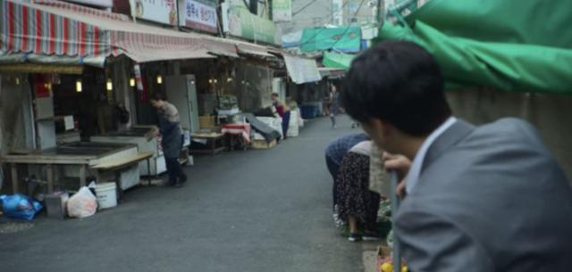 '오징어 게임'에서 수억 원의 빚을 진 상우가 어머니를 몰래 지켜보는 모습. 넷플릭스 캡처