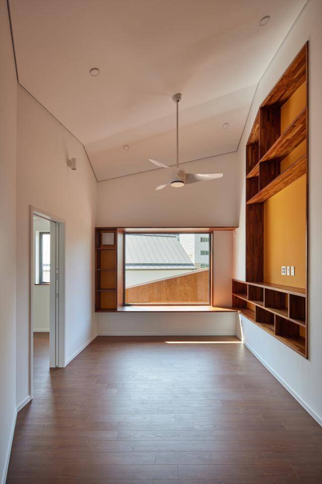 2층의 거실 모습. 천장도 바닥도 네모 반듯하지 않다. 건축가는 "아이들이 사선이 강한 공간에서 자라며 개성 강한 아이들이 되기를 바라는 마음을 담았다"고 했다. 노경 건축사진작가 제공