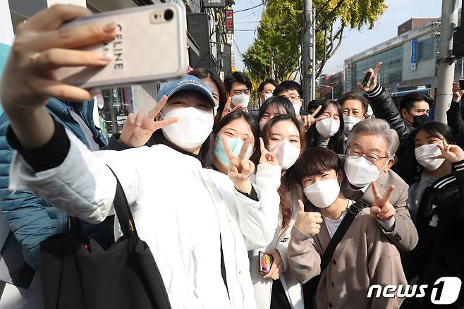 이재명 더불어민주당 대선 후보가 5일 오전 대구 북구 경북대학교 북문 인근에 도착해 학생들의 요청에 기념사진을 찍고 있다. 2021.11.5/뉴스1 © News1 공정식 기자