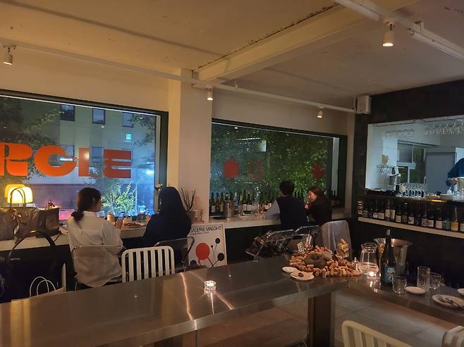 Visitors enjoy natural wine at Morcle, a natural wine bar in Hannam-dong, Seoul. (Park Yuna/The Korea Herald)