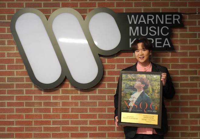 Tenor John Noh poses with his multi-platinum certificate for “The Classic Album: NSQG.” (Credia)