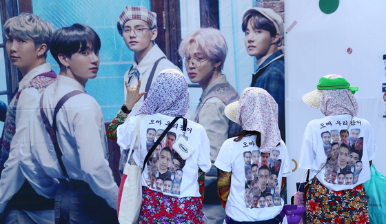 Fans of BTS, dubbed ARMY, wear t-shirts that have ″Oppa, we're here″ written on the back at the boy band's fan meet ″2019 BTS 5th Muster: Magic Shop″ held in Songpa District, southern Seoul, on June 22, 2019. [ILGAN SPORTS]