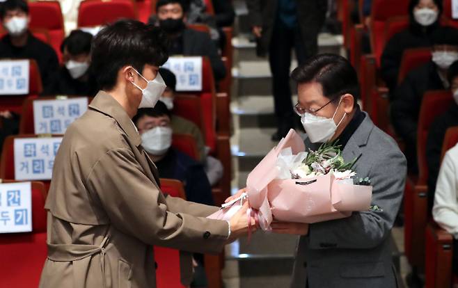 더불어민주당 이재명 대선 후보가 11일 경북 구미시 금오공과대학교에서 열린 '지역 대학생과 함께 나누는 대구경북의 미래 비전' 행사에 참석하며 이경재 2022년 총학생회장 당선자로부터 환영꽃다발을 받고 있다. 연합뉴스