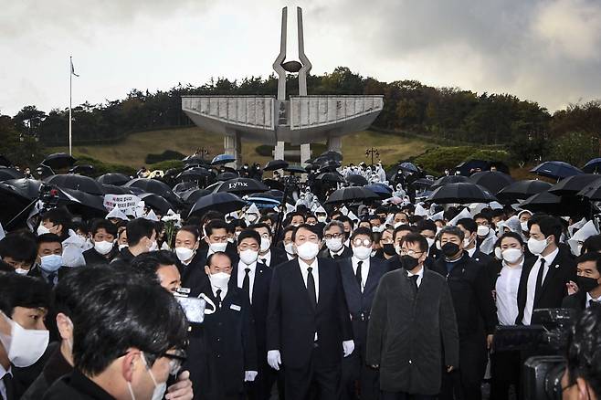 국민의힘 윤석열 대선후보가 11일 10일 광주 북구 국립 5·18 민주묘지 참배를 마친 뒤 걸어 나오고 있다. 윤 후보는 이날 5·18 민주묘지 추모탑에 헌화·분향하려 했으나 반대하는 시민들에 가로막혀 추모탑 입구에서 묵념으로 참배를 대신했다. /연합뉴스