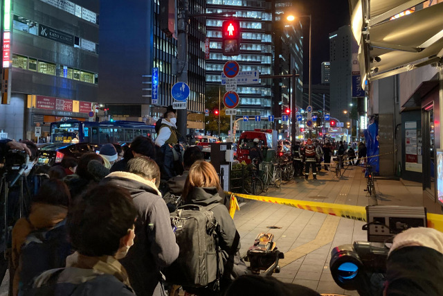 17일 화재가 발생한 일본 오사카 건물 주변에 모여든 시민들이 안타까운 모습으로 현장을 지켜보고 있다. /AP연합뉴스