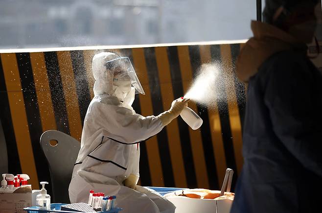 광주 북구 선별진료소에서 보건소 의료진이 코로나19 검체를 채취한 다음 소독하고 있다. /광주북구청, 연합뉴스